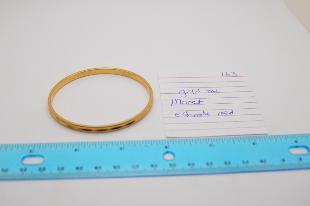 Thin gold bangle bracelet, signed Monet, 163