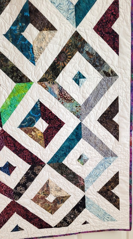Hand made 55" X 62" Quilt In multiple batiks, purple batik back. Patchwork