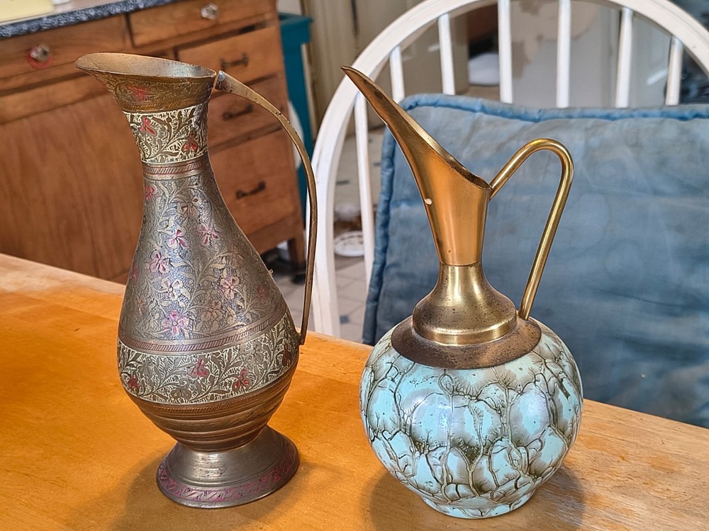 2Copper pitchers one all copper and another a unique blue design