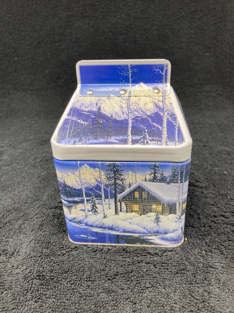 Winter mountain cabin scene tin