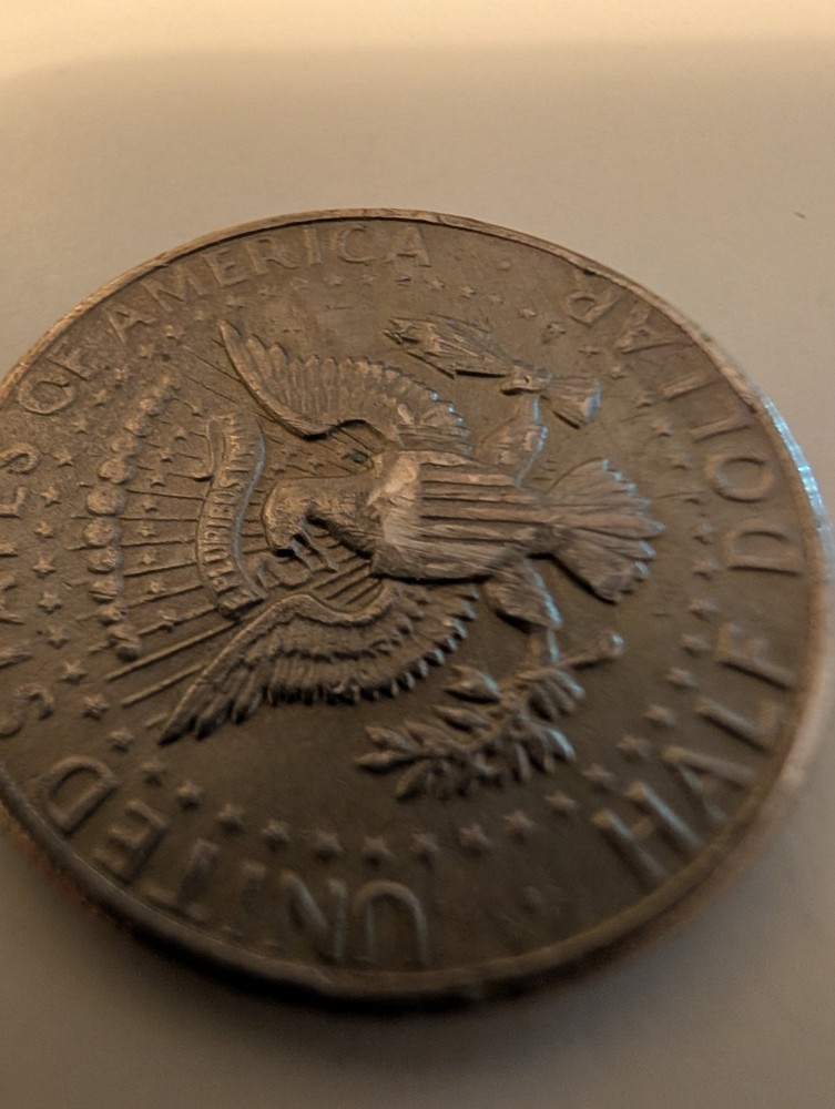 1971 Half Dollar Struck Through Wire And Error On His Cheek