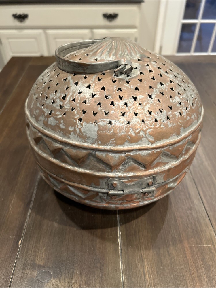Antique Middle Eastern copper lidded storage container with geometric patterns.