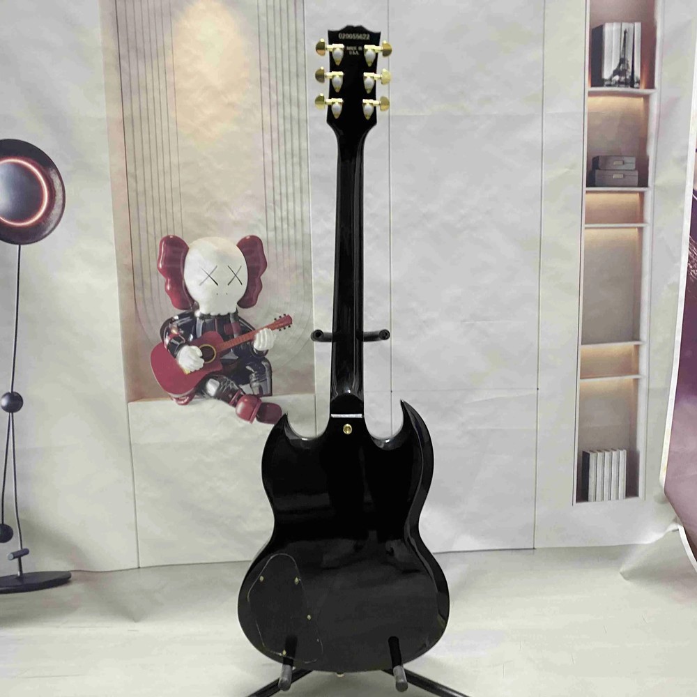 Black 6-string electric guitar with HH pickup, gold hardware, solid body