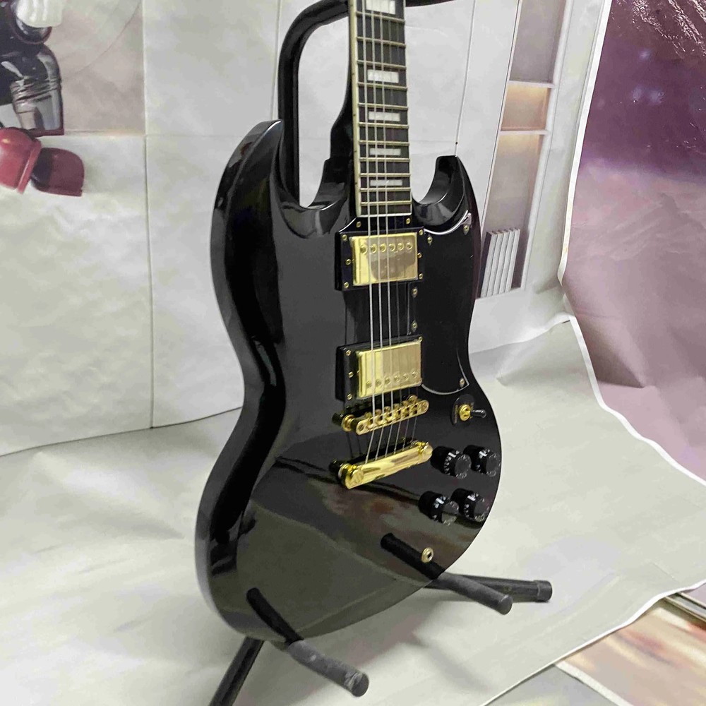 Black 6-string electric guitar with HH pickup, gold hardware, solid body