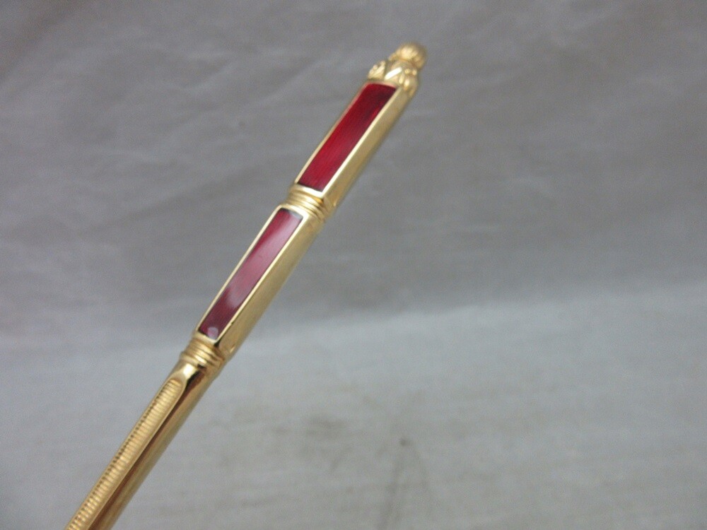Gold plated cake server with red enamel handle