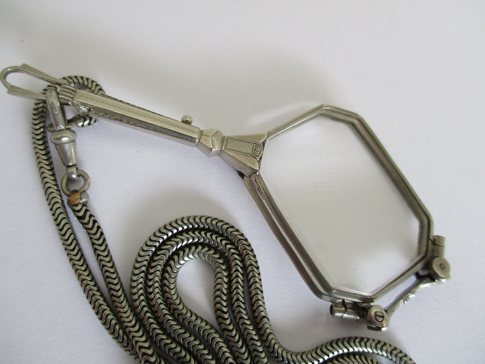 A Deco style lorgnette with guard chain