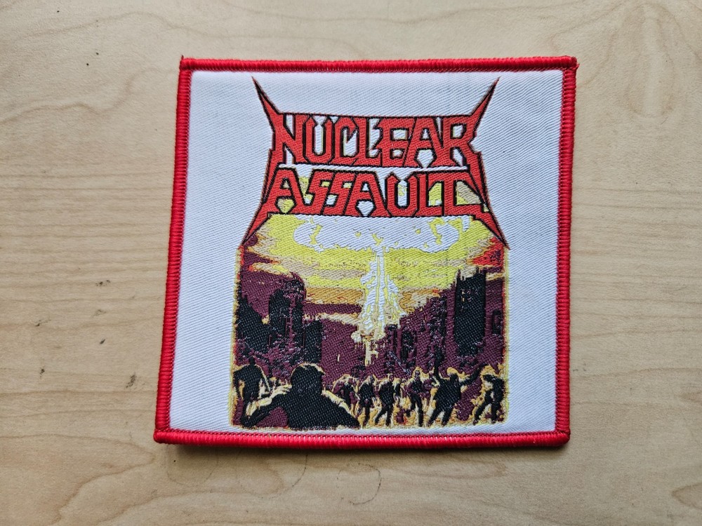 NUCLEAR ASSAULT, SEW ON RED BORDER WOVEN PATCH