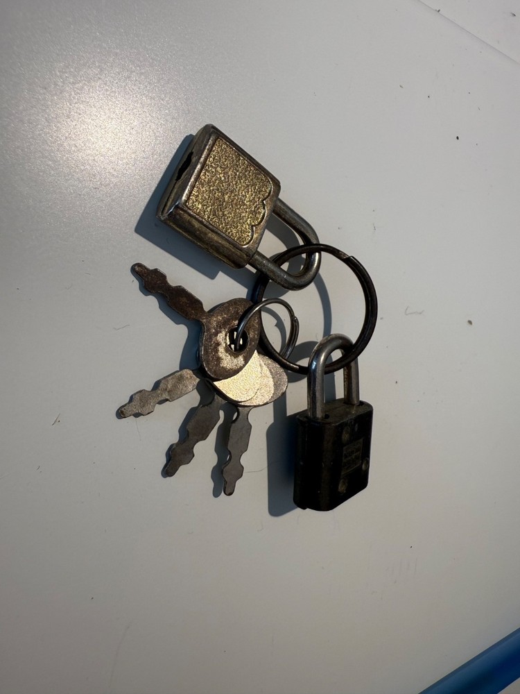 Two small luggage locks with four keys