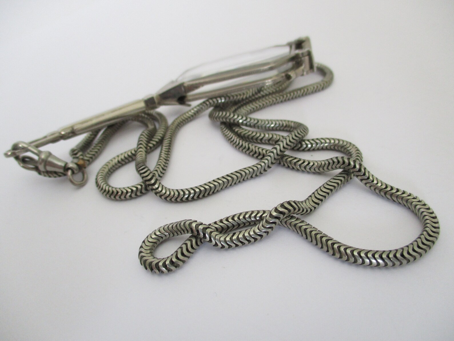 A Deco style lorgnette with guard chain