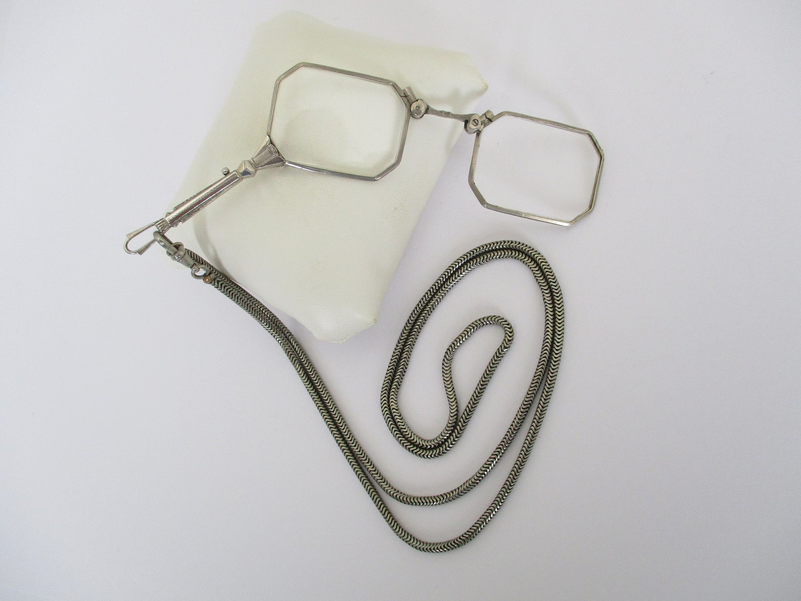 A Deco style lorgnette with guard chain