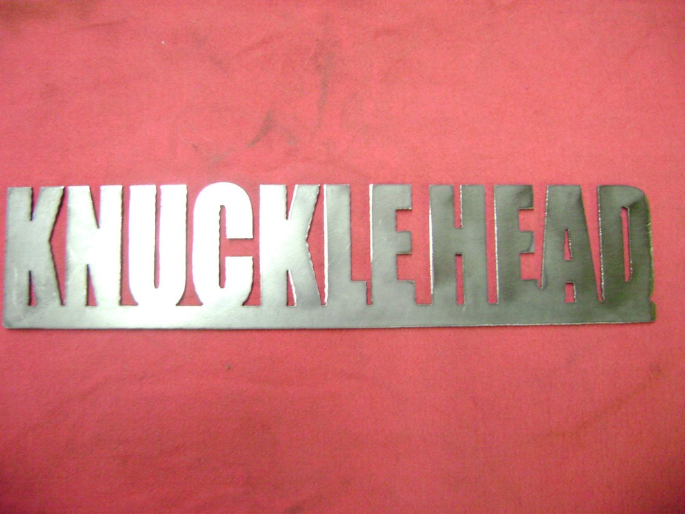 RAW METAL "KNUCKLE HEAD" SIGN.