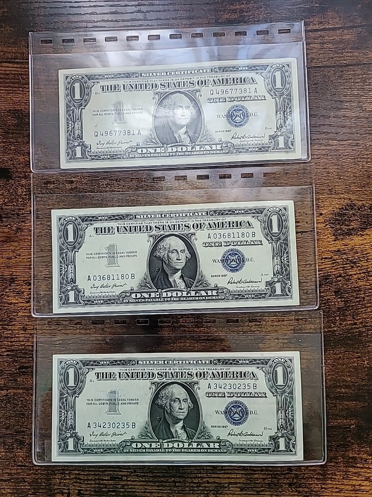 One Dollar 1957 Silver Certificates Blue Seal. Three Total