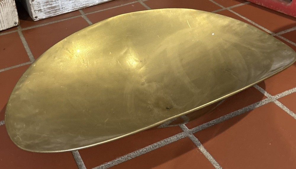 A large, antique solid brass mercantile scale pan.