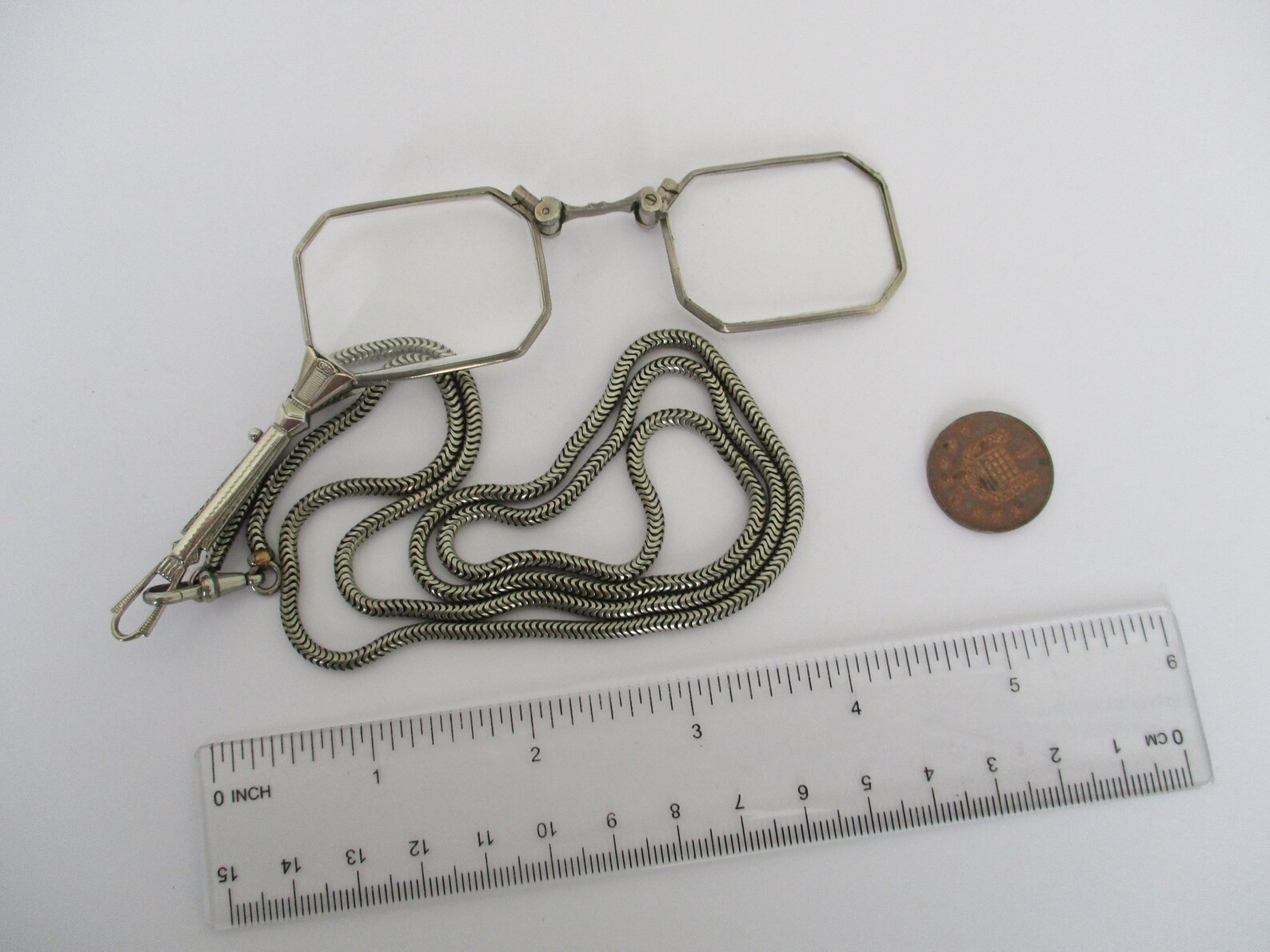 A Deco style lorgnette with guard chain