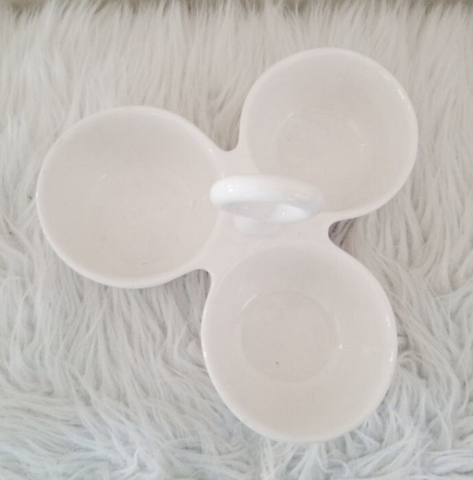 Condiment tray separated dishes.