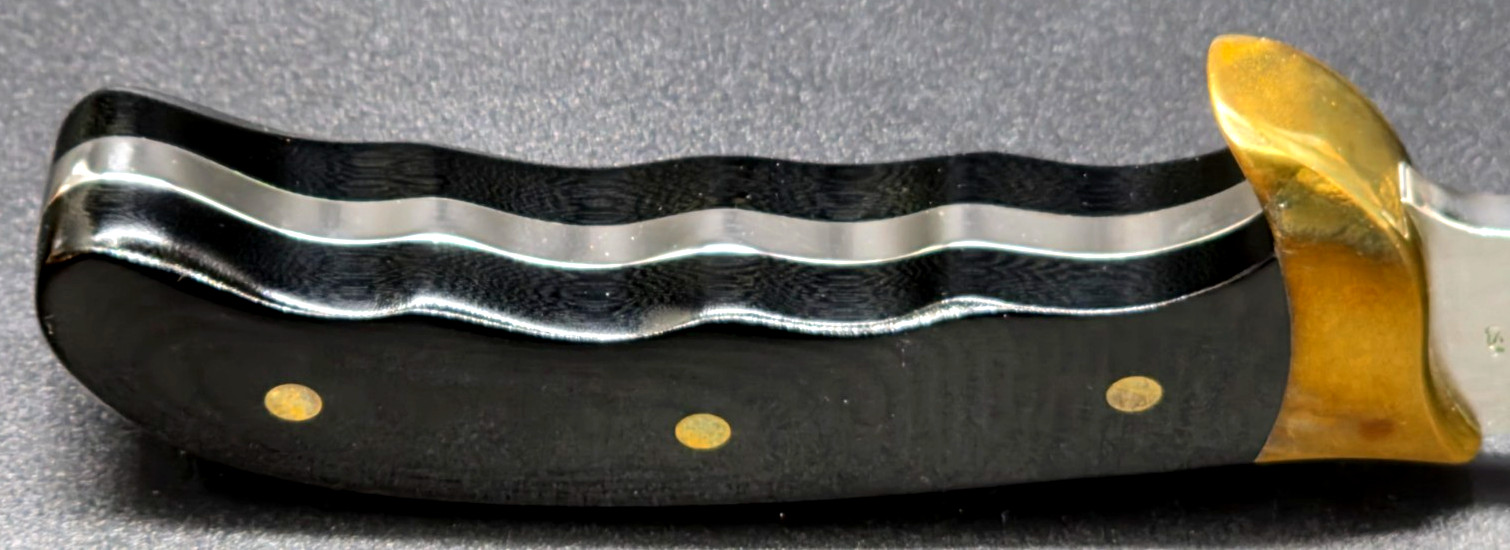 Buck Kalinga knife with black handle and brown leather sheath