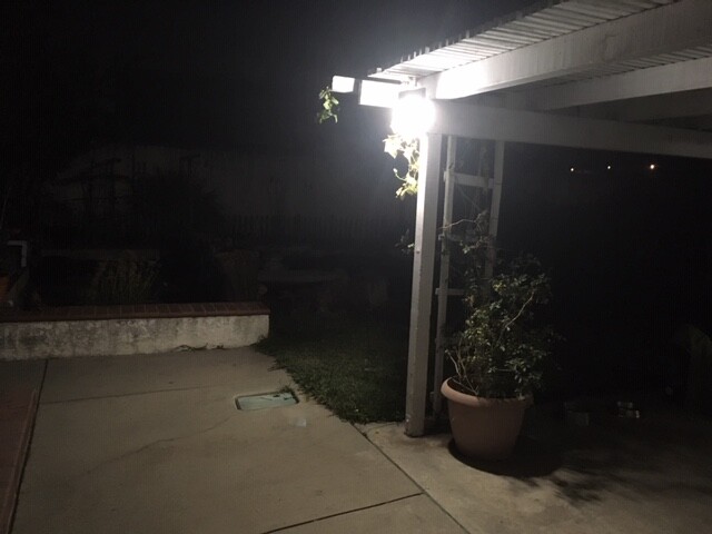 A WALL SECURITY FIXTURE WITH 9 WATT LED LIGHT BULB