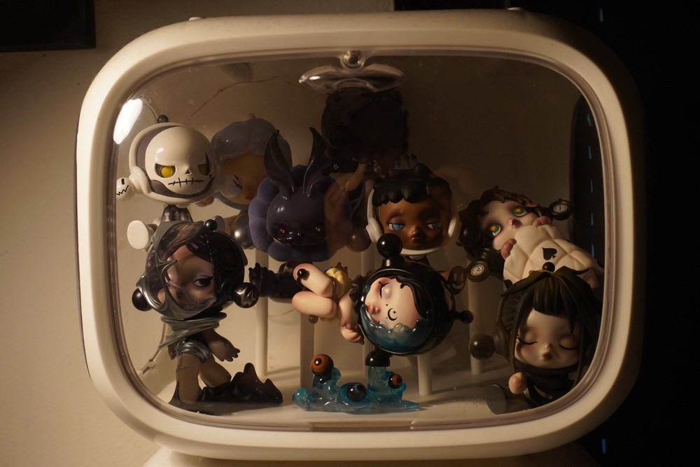 White display case with 17 Skillpanda figures. both in excellent condition