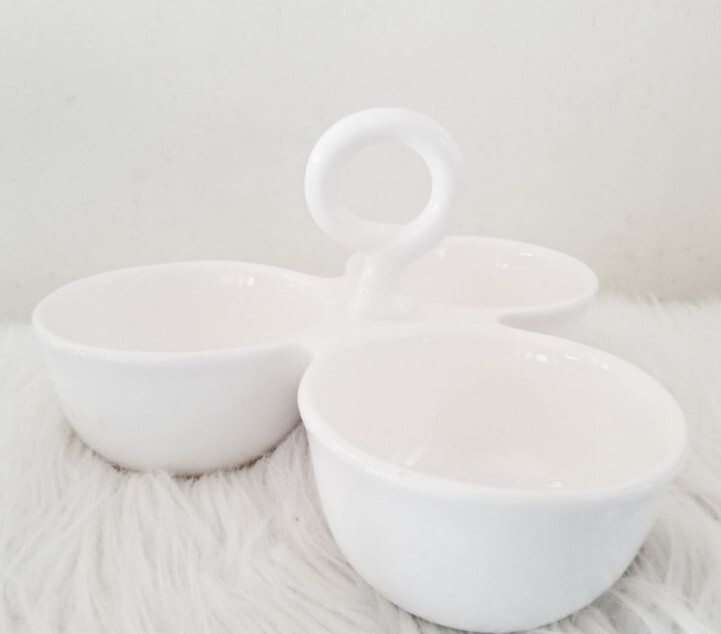 Condiment tray separated dishes.