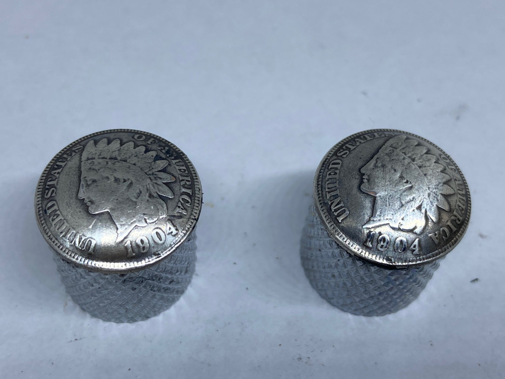 Silver toned Indian penny guitar knobs with knurled sides.