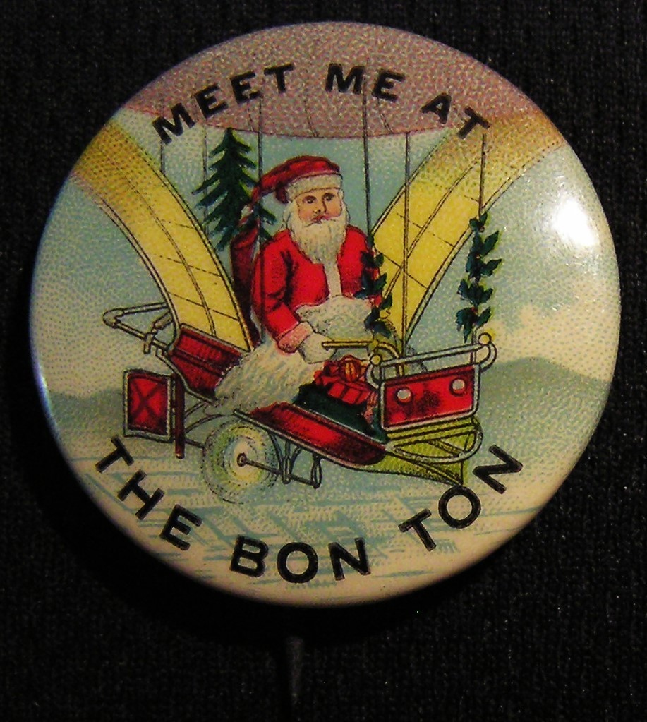 RARE ANTIQUE SANTA CLAUS "MEET ME AT THE BON TON" FLYING MACHINE AIRSHIP PIN