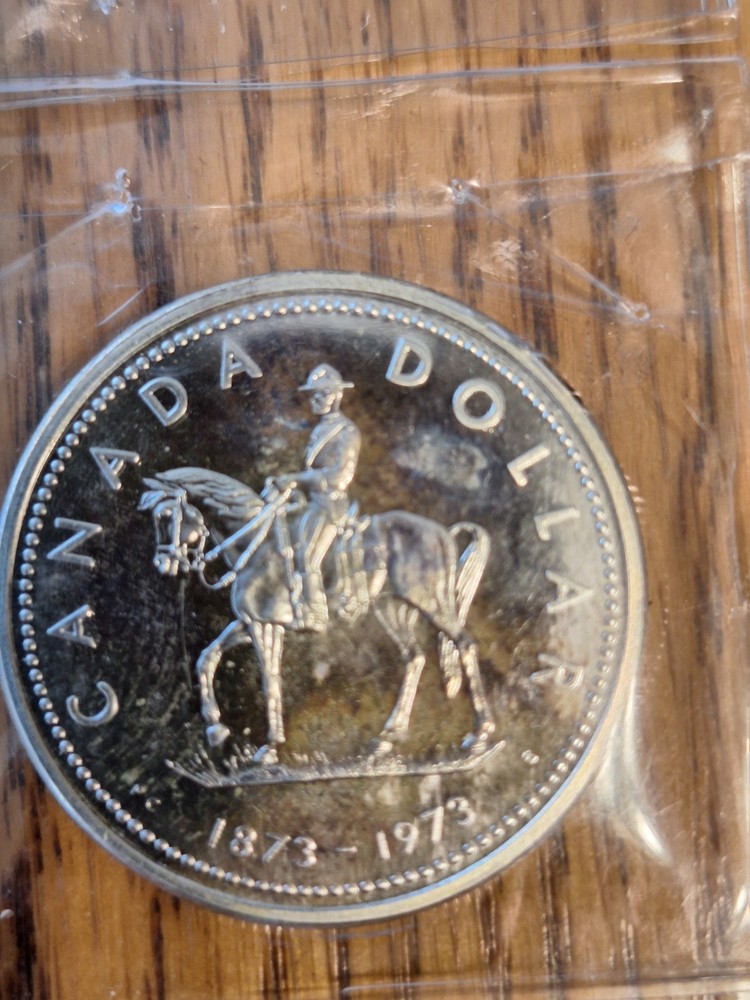 Rainbow Toned 1973 Canada RCMP Uncirculated Silver Dollar