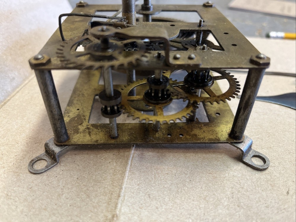 ANTIQUE E INGRAHAM CO CLOCK MOVEMENT AND PENDULUM BOB