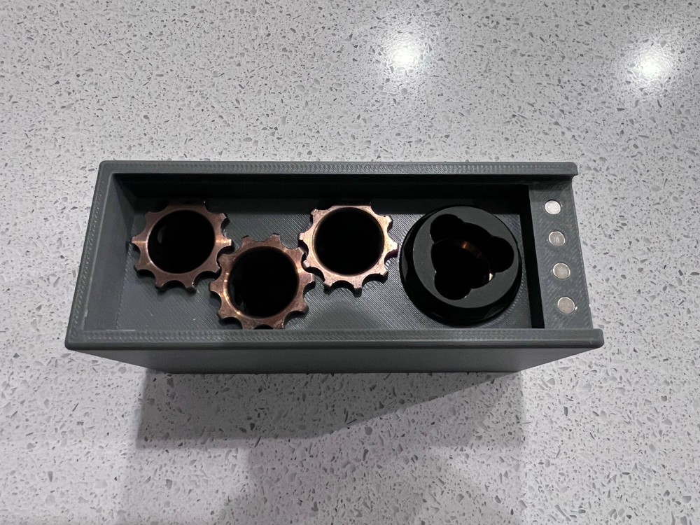 Rugged Obsidian piston/booster storage case and multi-tool