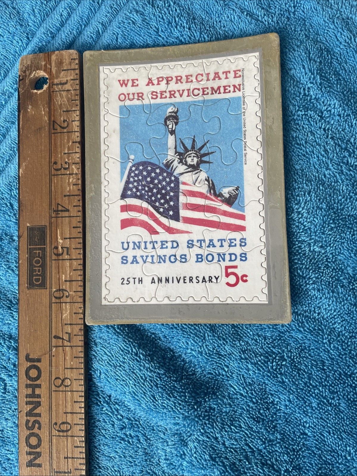 Vintage novelty puzzle resembling a US Savings Bond postage stamp.