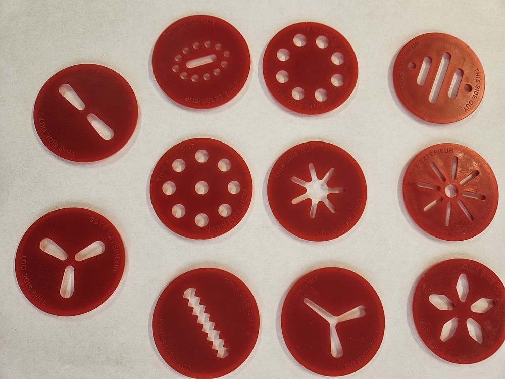 11 RED PLASTIC DISCS FROM A WHITE WILTON COOKIE PRESS
