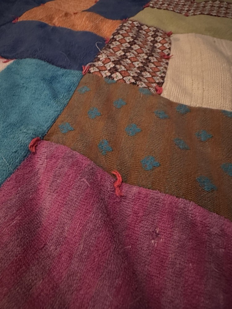 Handmade patchwork quilt with geometric 'L' block pattern.