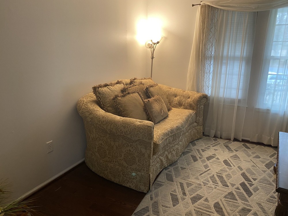 A Set Of Beige Sofas And A Coffee Table