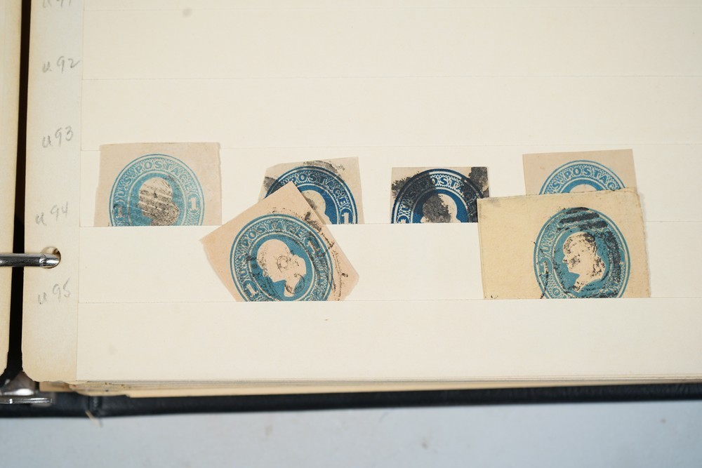 US COLLECTION OF 1,200+ STATIONERY CUT SQUARE STAMPS STORED IN STOCKBOOK