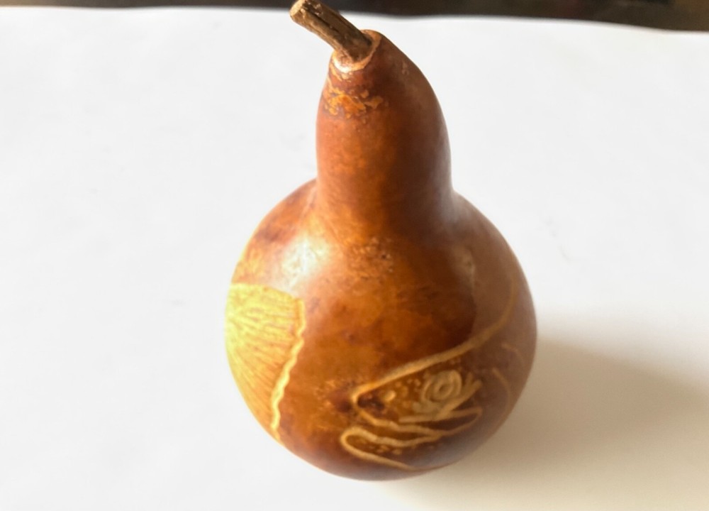 Decorative gourd etched with fish.