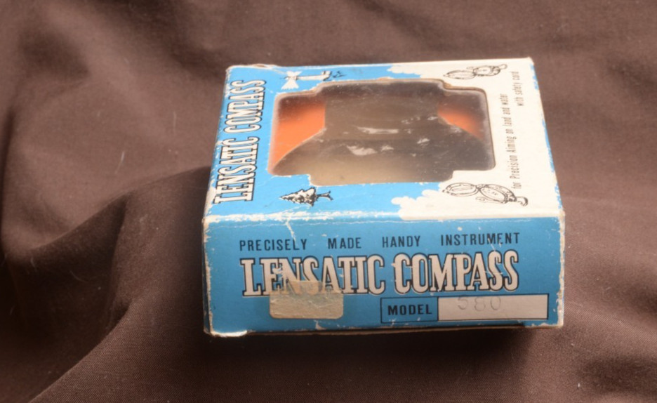 two lensatic compasses one with box