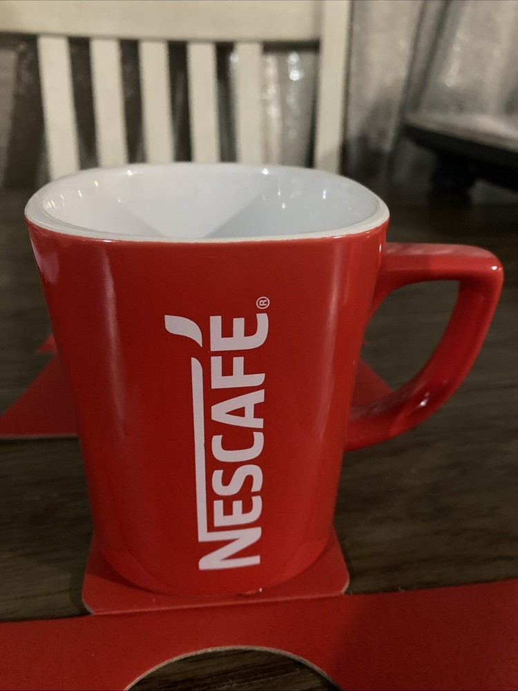 Mug Coffee & 3 packets Inside Dark Roast Nescafe Clasico.