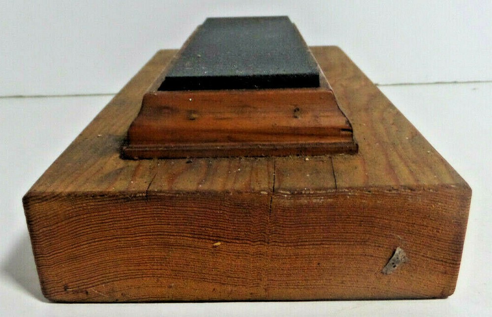 sharpening stone mounted on wood base