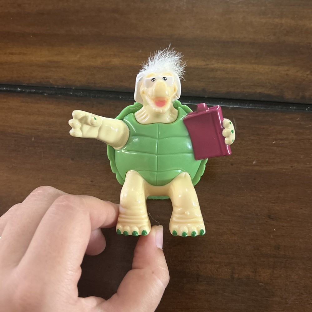 Old Turtle Toy Holding A Book