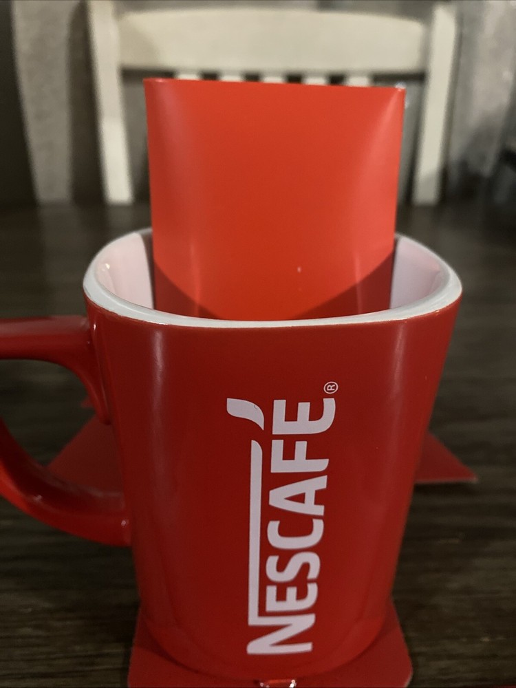 Mug Coffee & 3 packets Inside Dark Roast Nescafe Clasico.