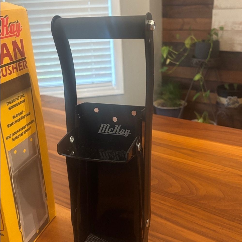 McKay Wall Mounted Can Crusher in Black includes bottle opening function
