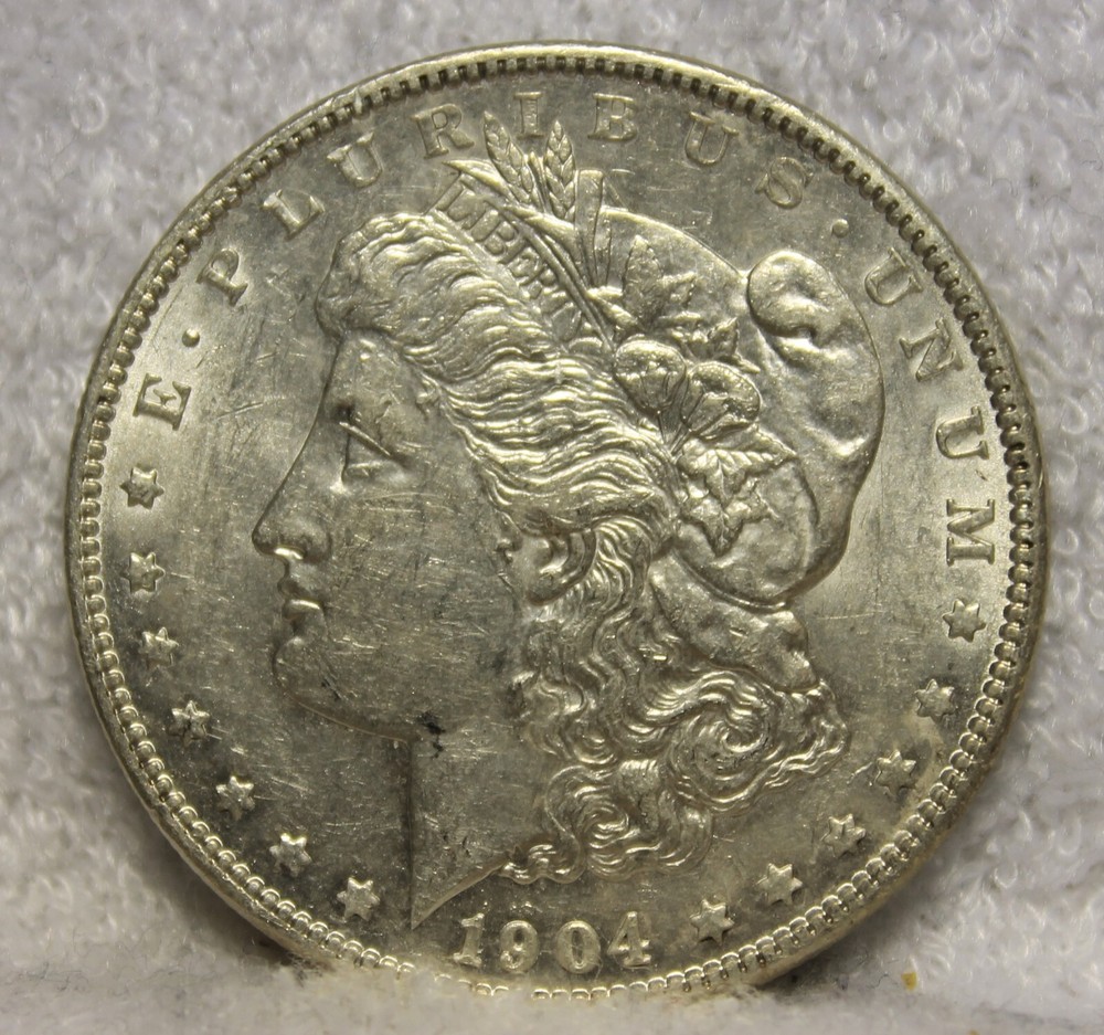 1904 AU plus Morgan Silver Dollar