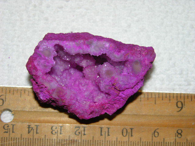 Geode cut & polished half with colored crystal center 2 inch E4