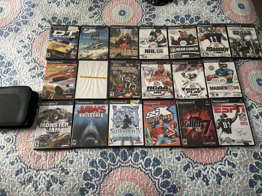 playstation 2 . The console , three controls with various games.