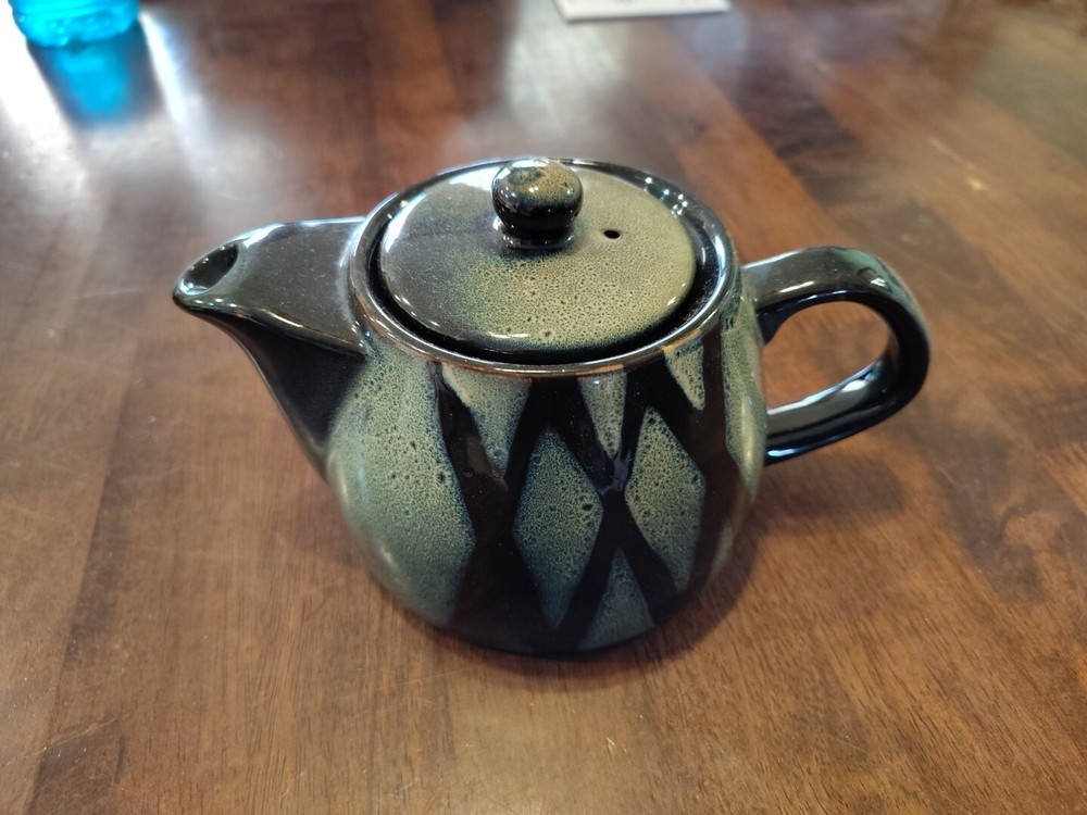 black with green ceramic teapot