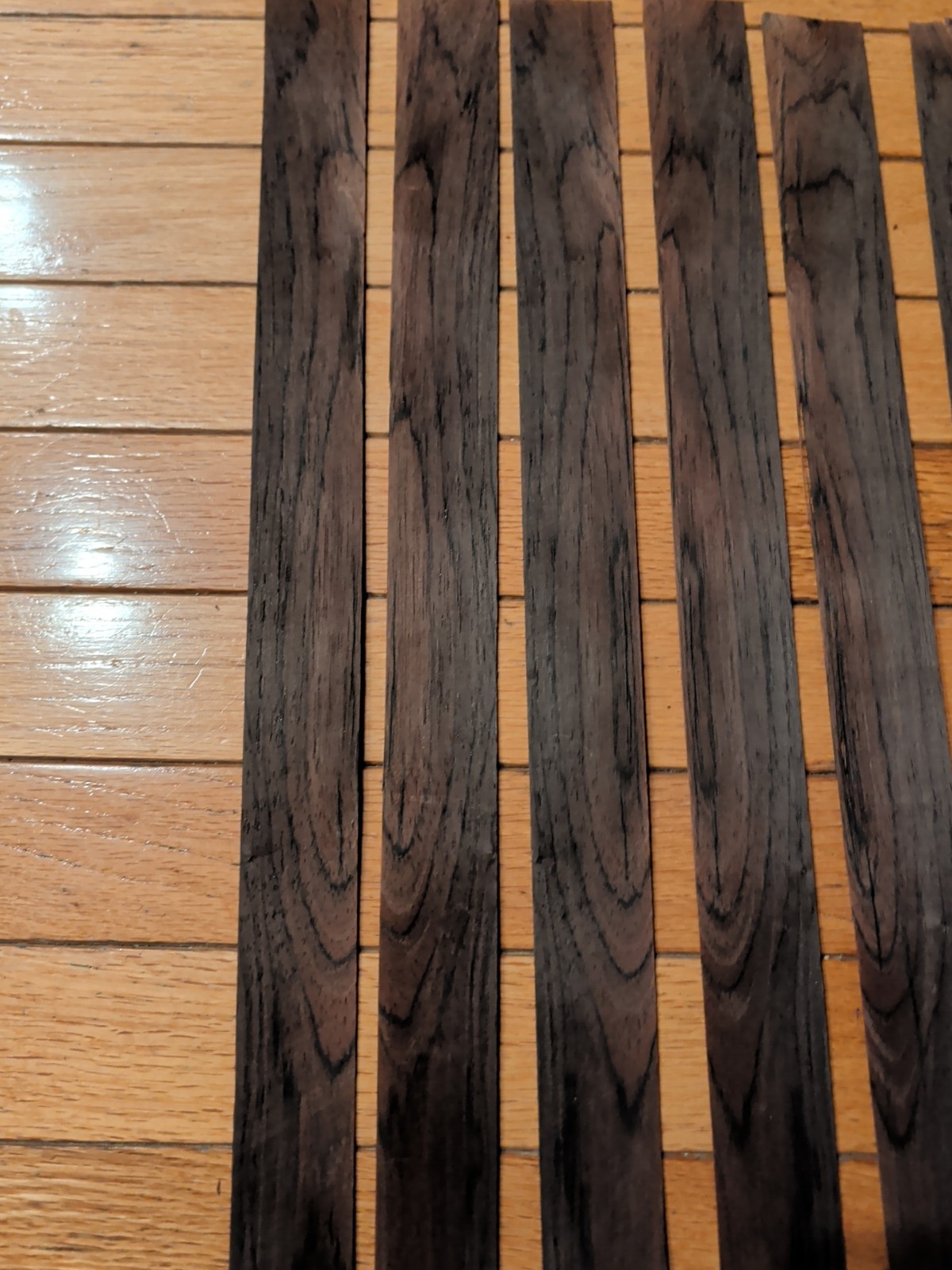 7 pieces of rosewood veneer 1 1/4" to 1 1/2" x 24 1/2" each raw 1/42"