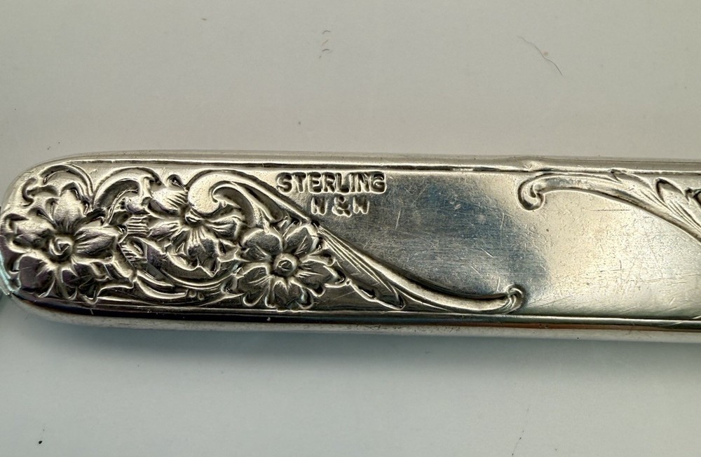 This is an antique sterling silver chatelaine pencil holder