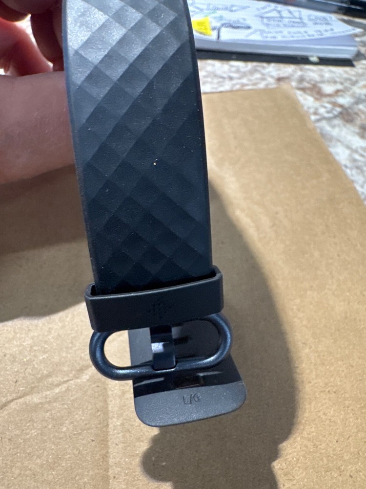 fit bit charge 3 or 4 , tiny ding on bottom of screen