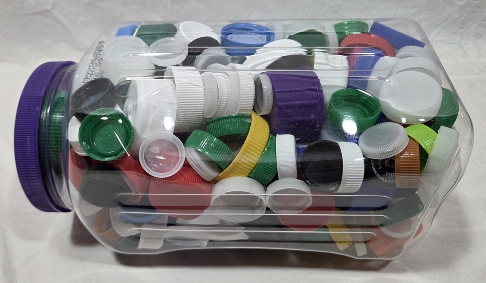 Assorted Plastic Lids And Caps In 26 Ounce Plastic Canister