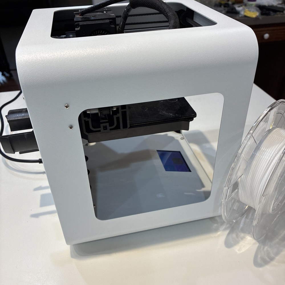 TOYBOX 3D Printer with white printer food.