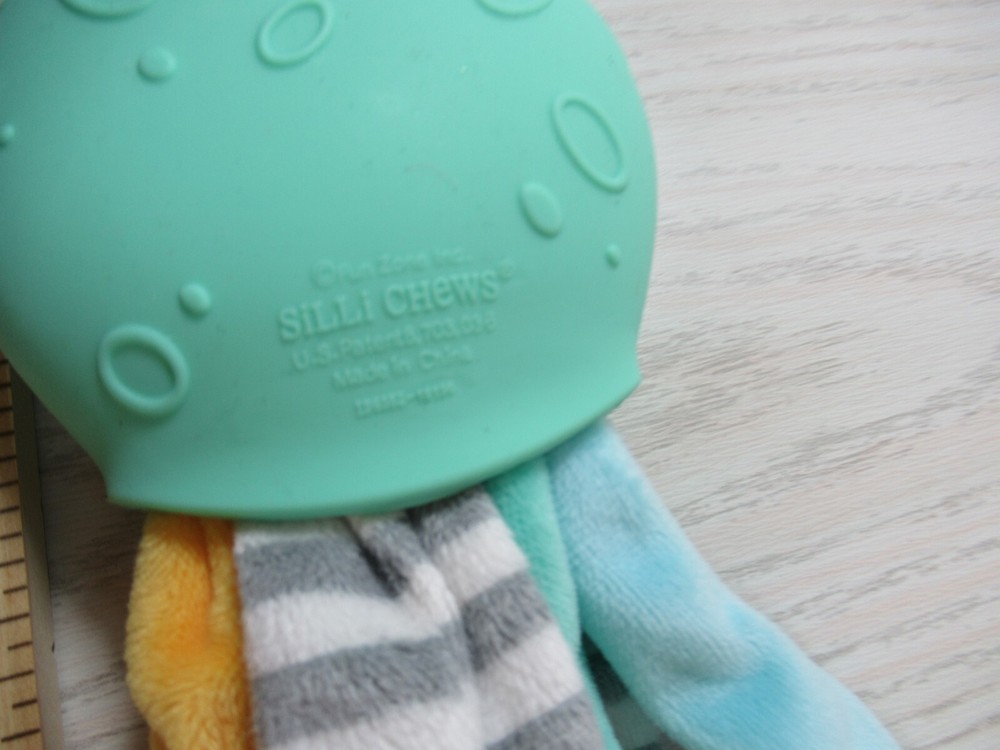 Silli Chews green octopus teether plush multi-colored legs tentacles gray stripe